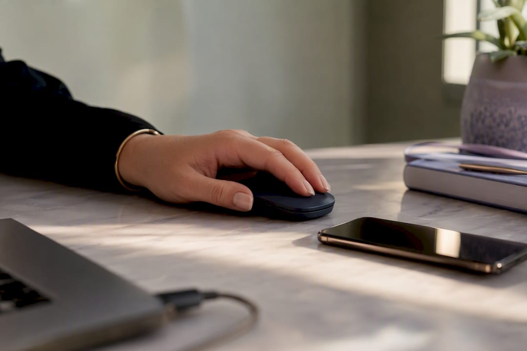 Luxury real estate agent's hand near devices on desk